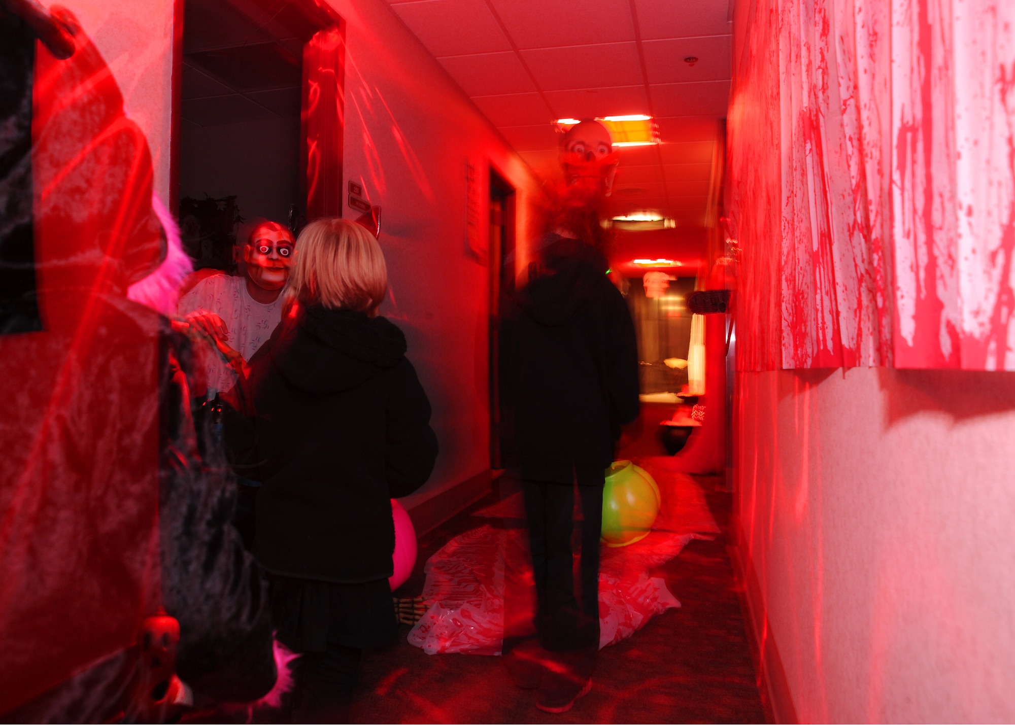 A group of children walk through the “Hades” hallway during the annual indoor trick-or-treating event Oct. 31, 2012, on Grand Forks Air Force Base, N.D. The 319th Medical Group hosts trick-or-treating every year as a way for children and families to enjoy the holiday. (U.S. Air Force photo/Airman 1st Class Xavier Navarro)