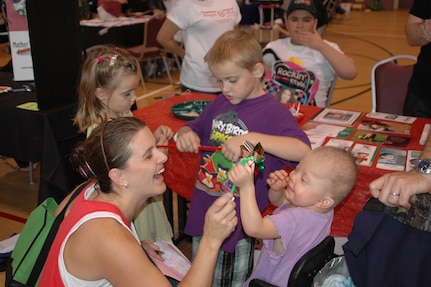 Heather Strable and her children (from left) Landen, 5, Langston, 6, and Ellyson, 3, enjoy the Joint Base San Antonio Special Needs Resource Fair and Activity Day Oct. 13 at Morgan’s Wonderland. Langston and Landen attend Randolph Elementary School. (U.S. Air Force photo by Robert Goetz)