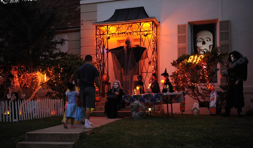 Michelle Makalena and Maj. Dan Makalena, far right, Air Force Global Strike Command, wait to give candy out to costumed Airmen and their families during Halloween on Barksdale Air Force Base, La., Oct. 31. Barksdale Airmen and their families decorated their homes and dressed up in costumes to celebrate Halloween. (U.S. Air Force photo/Airman 1st Class Benjamin Gonsier)(RELEASED)
