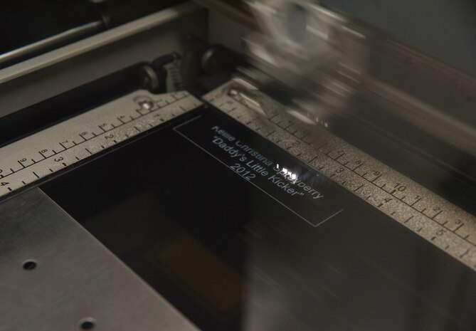 The Epilog laser helix engraves a plate for a customer Oct. 29, 2012 at Joint Base Charleston - Air Base, S.C. The laser engraver is used to personalize metal plates, glass, acrylic and wood with names and sentiments. It can engrave a variety of things including Air Force, Navy, Army, Marine, and Coast Guard insignia and emblems, scholar and sport pins, religious images, and quality and excellence pins. (U.S. Air Force photo/Airman 1st Class Ashlee Galloway