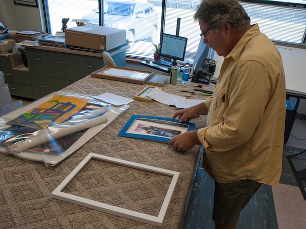 Kevin Parent, 628th Force Support Squadron master framer, fits a mat to a painting Oct. 29, 2012 at Joint Base Charleston - Air Base, S.C. A computerized mat cutter enables the framer to include three-dimensional bevels, offset corners, ovals, circles, ribbons, shapes, and designs. (U.S. Air Force photo/Airman 1st Class Ashlee Galloway)