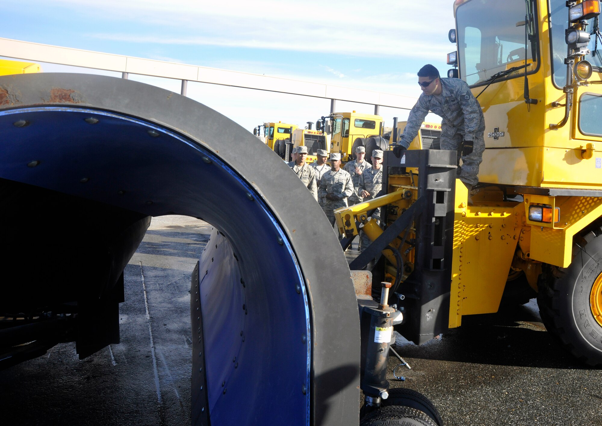Members of the 11th Civil Engineer Squadron’s snow-removal team learn to affix a scraper to an airfield snow plow during pre-season snow-removal training on the Andrews flight line Oct. 18, 2012. Team members spent time familiarizing themselves with each piece of heavy snow-removal equipment, ensuring their confidence in its operation before the winter storm season. (U.S. Air Force photo/Senior Airman Lindsey Porter)