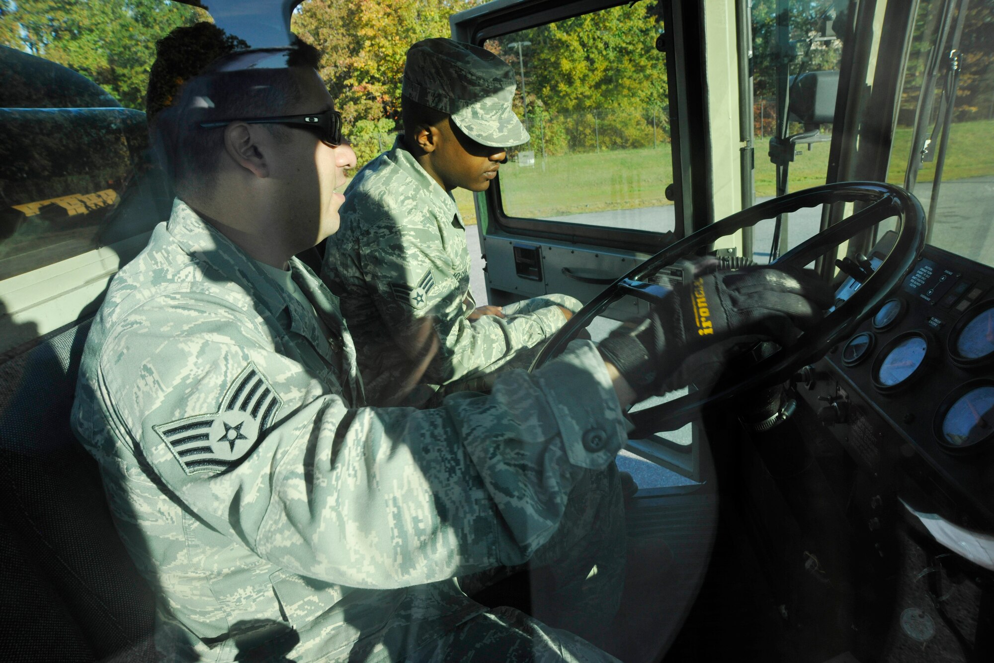 Staff Sgt. Mario Turner, 11th Civil Engineer Squadron heavy equipment operator and snow-removal training instructor, left, and Senior Airman Jonathon Joshua, 11th CES utilities craftsman, review operating procedures on a flight line snow blower on Andrews flight line Oct. 18, 2012. During snow-removal training, members of the 11th CES familiarize themselves with some of Andrews’ largest snow-removal vehicles including flight line snow blowers, snow plows and dump trucks. (U.S. Air Force photo/Senior Airman Lindsey Porter)
