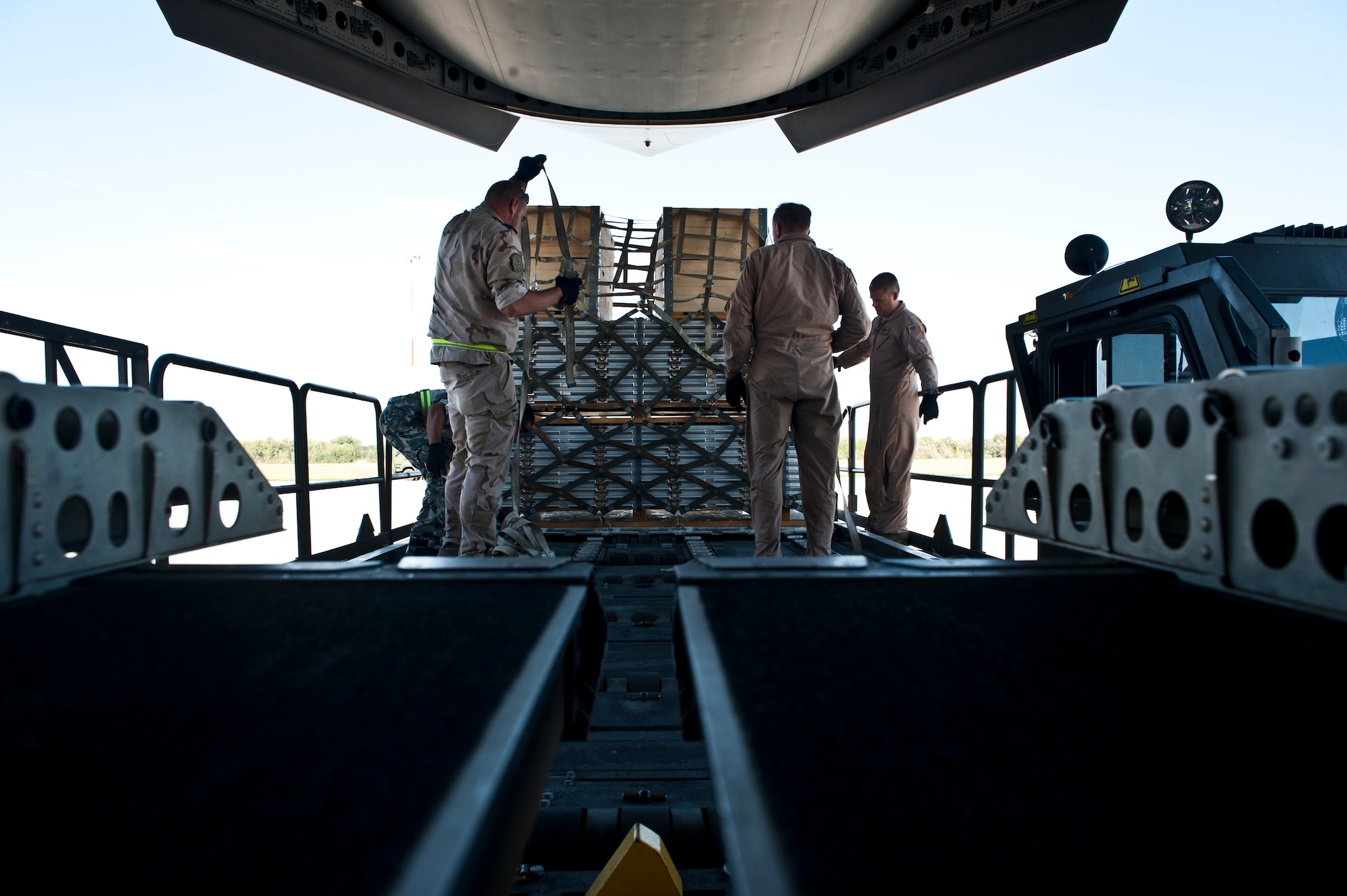 Aerial porters of the Heavy Airlift Wing at  Papa Air Base, Hungary remove pallets from a C-17 Globemaster III after a recent Swedish mission. The wing operates a fleet of three Globemaster III long-range cargo jets under the Strategic Airlift Capability program that consists of ten NATO nations Bulgaria, Estonia, Hungary, Lithuania, the Netherlands, Norway, Poland, Romania, Slovenia and USA and two Partnership for Peace nations, Sweden and Finland. (U.S. Air Force photo/Tech. Sgt. Bennie J. Davis III)