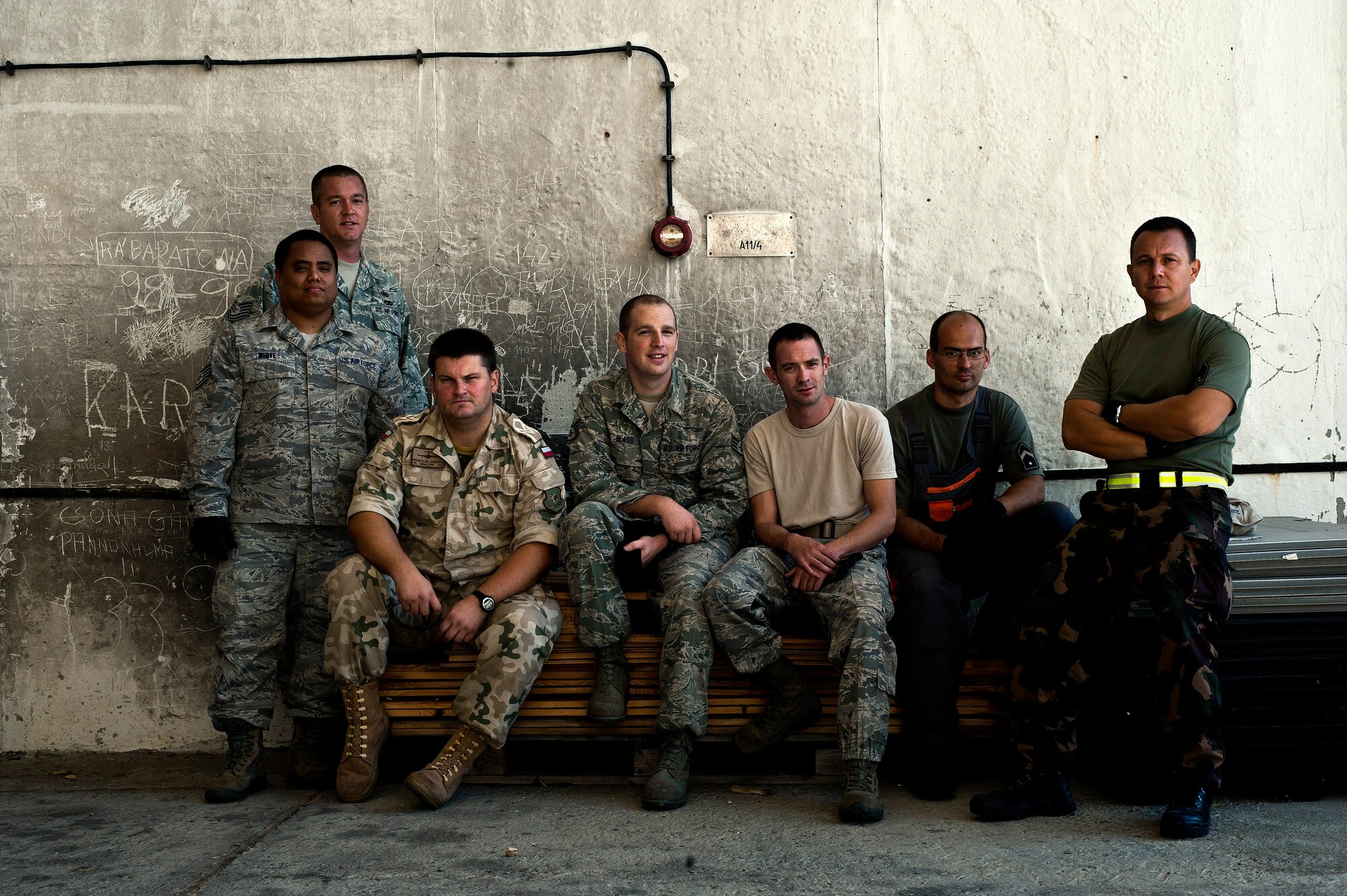 (From left) Tech. Sgt. Brian Robisky, Tech. Sgt. Kevin White, Polish air force Sgt. Przemyslaw Jakubczak, Staff Sgt. Erik Blass, Staff Sgt. Justin Van Schefel, Hungarian air force Capt. Tamas Soter and Hungarian air force Sgt. Ternec Gelenscer are aerial porters assigned to the Heavy Airlift Wing at Papa Air Base, Hungary. The aerial porter section is made up of nine members from five different countries, who work alongside their Hungarian counterparts. (U.S. Air Force photo/Tech. Sgt. Bennie J. Davis III)