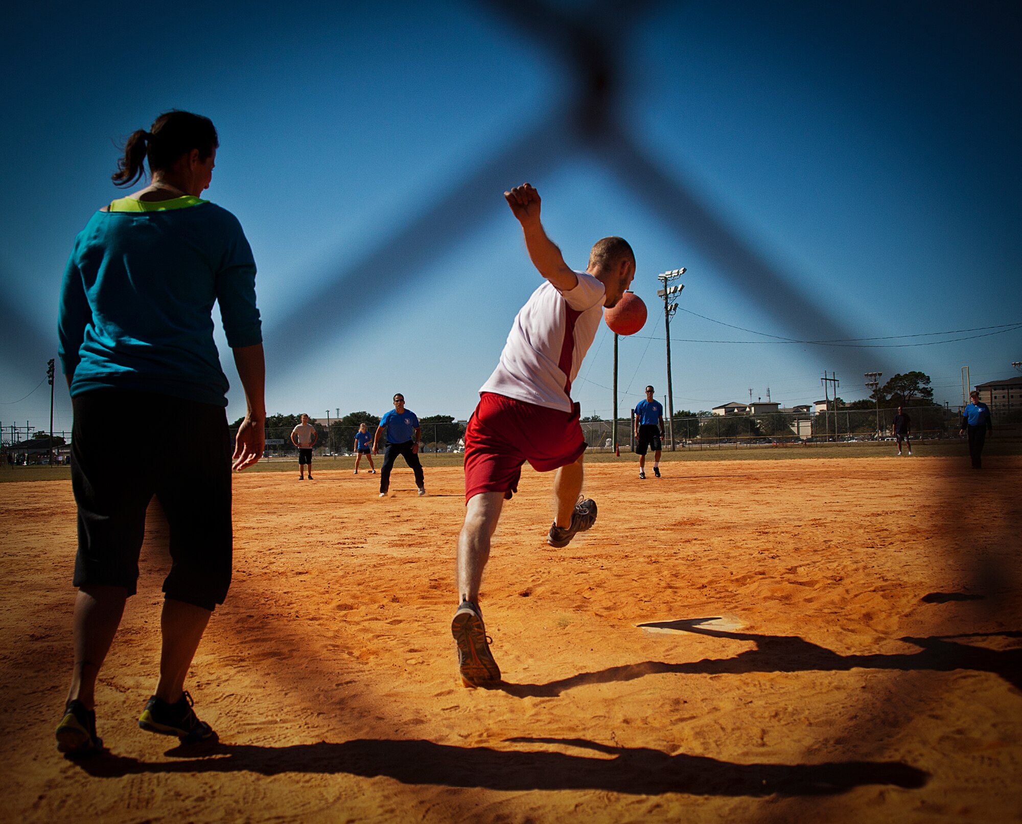 An Airman boots the ball toward the 96th Wing Staff Agency outfield during a kickball match at the 96th Test Wing’s Wingman Day event Oct. 31 at Eglin Air Force Base, Fla.  Hundreds of Airmen and civilians participated in physical and non-physical challenges highlighting teamwork and resiliency.  (U.S. Air Force photo/Randy Gon)
