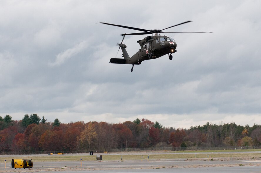 HANSCOM AIR FORCE BASE, Mass. -- A UH-60 Blackhawk helicopter ferrying members of the 10th Mountain Division Combat Aviation Brigade arrives at Hanscom Oct. 31, where the brigade is being positioned for possible hurricane relief support. Base staff have been working hard to support the brigade's efforts, providing flight line operations, billeting and other on-site assistance. (U.S. Air Force Photo by Rick Berry)