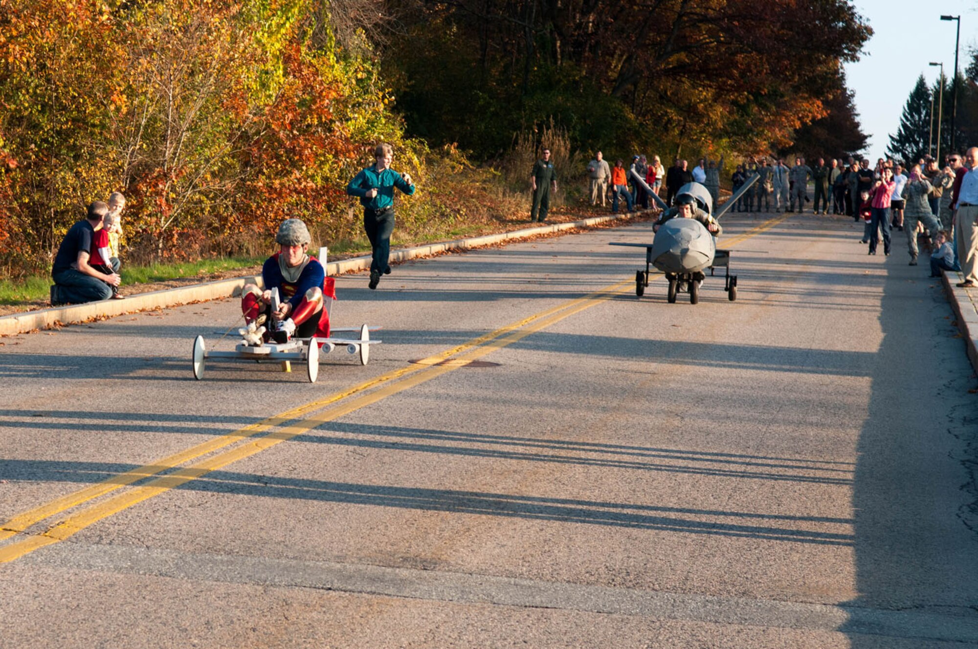 HANSCOM AIR FORCE BASE, Mass. – 2nd Lt. George Steel (left), Joint STARS systems engineer, races against Lt. Col. Michael Harm, MP-RTIP materiel leader, during the first annual Battle Management Wingman Day Soap Box Derby Oct.26. The two finished the race with Joint STARS edging out for the win. (U.S. Air Force Photo by Rick Berry)