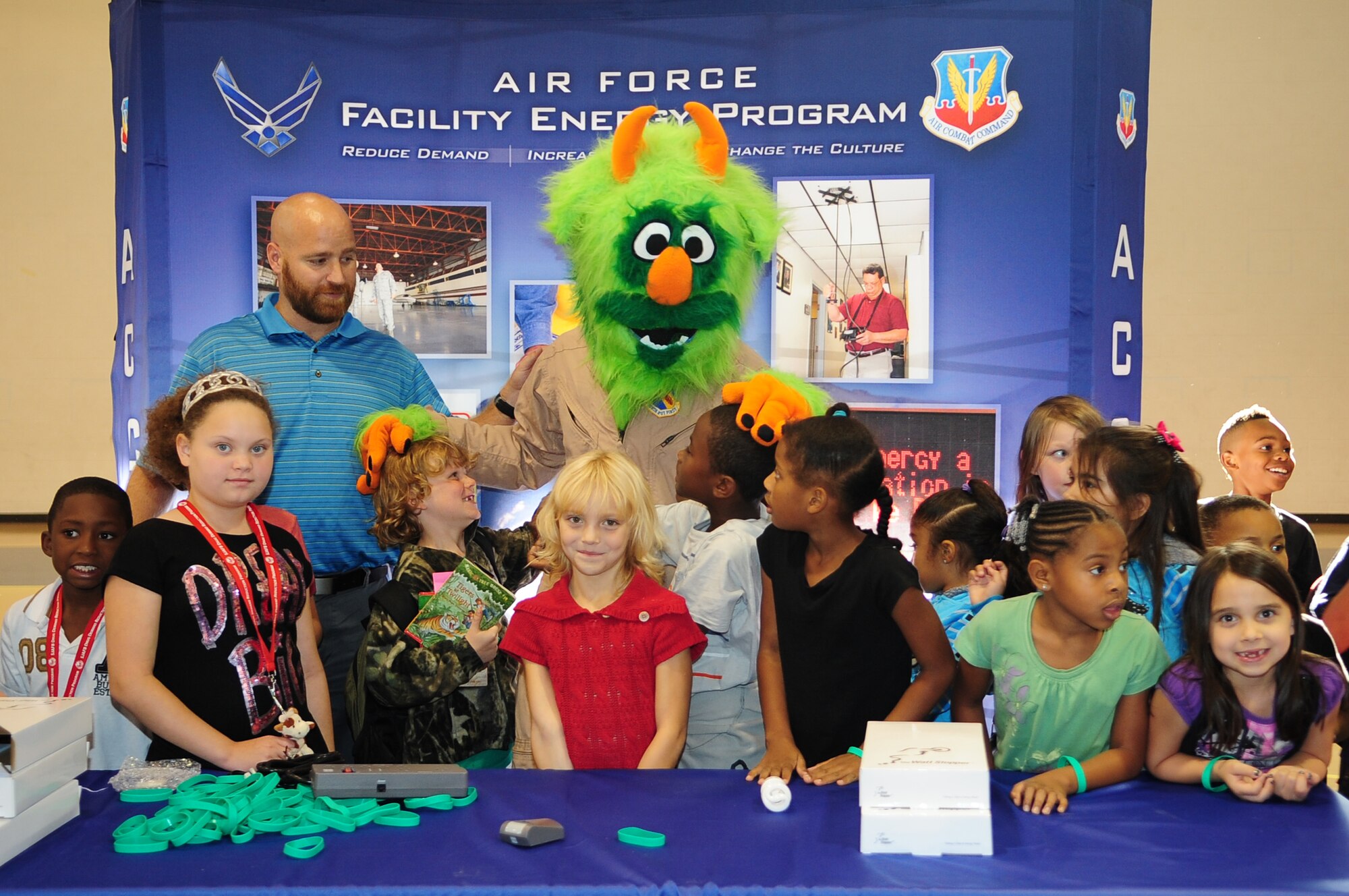 Matthew Latham, 4th Civil Engineer Squadron installation energy manager, and “Airman e-BEAST,” 4th CES energy awareness mascot, speak to children during National Energy Awareness Month on Seymour Johnson Air Force Base, N.C., Oct. 24, 2012. Latham used interactive learning to teach children the importance of conserving energy on base and at home. (U.S. Air Force photo/Airman 1st Class Aubrey White/Released)