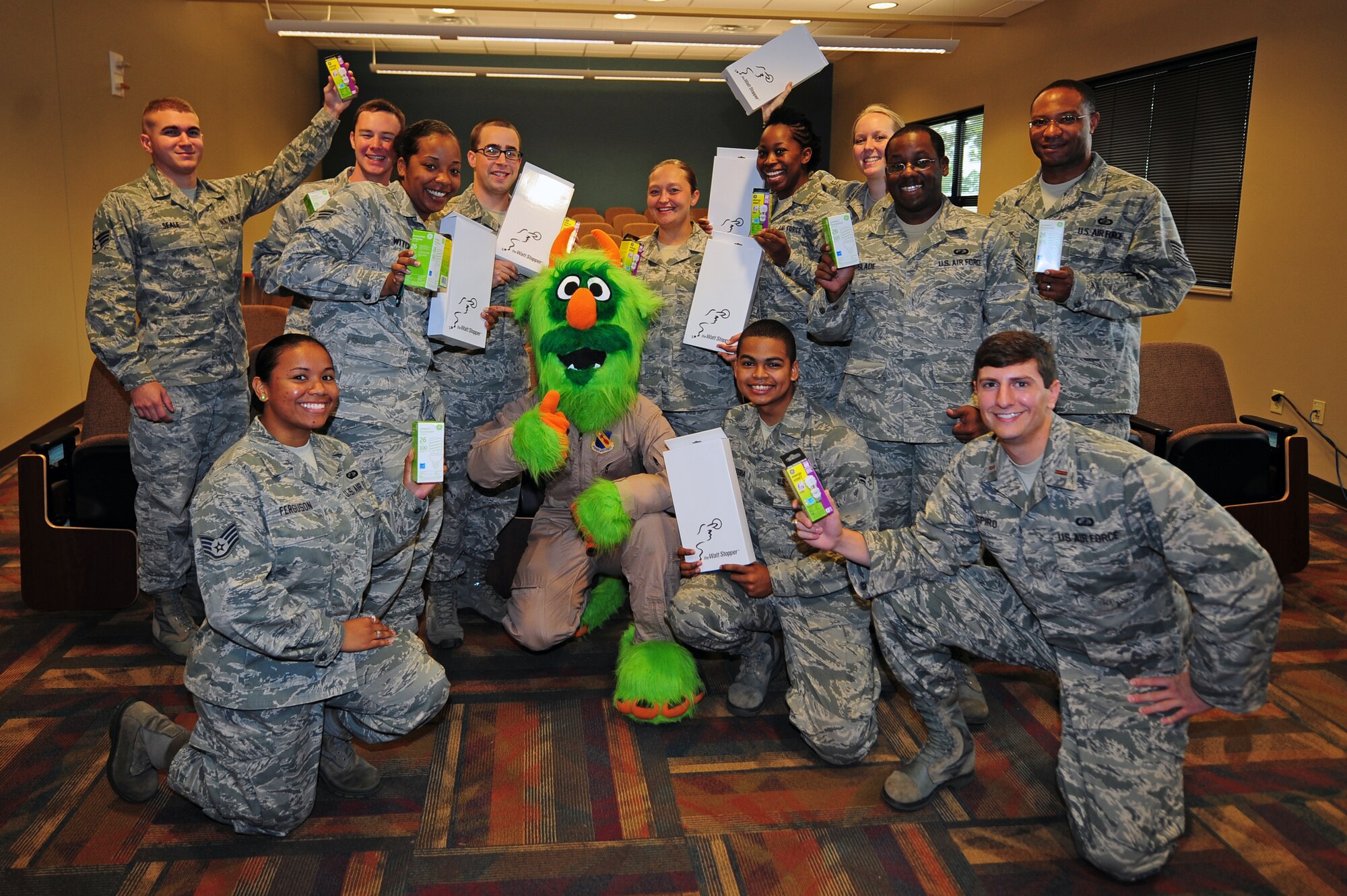 U.S. Air Force Airmen assigned to the 4th Comptroller Squadron pose with “Airman e-BEAST,” 4th Civil Engineer Squadron energy awareness mascot, after receiving energy efficient products during National Energy Awareness Month on Seymour Johnson Air Force Base, N.C., Oct. 17, 2012. “Airman e-BEAST” visited the base’s Consolidated Support Center to spread energy efficiency tips to Airmen and their families (U.S. Air Force photo/Airman 1st Class Aubrey White/Released)