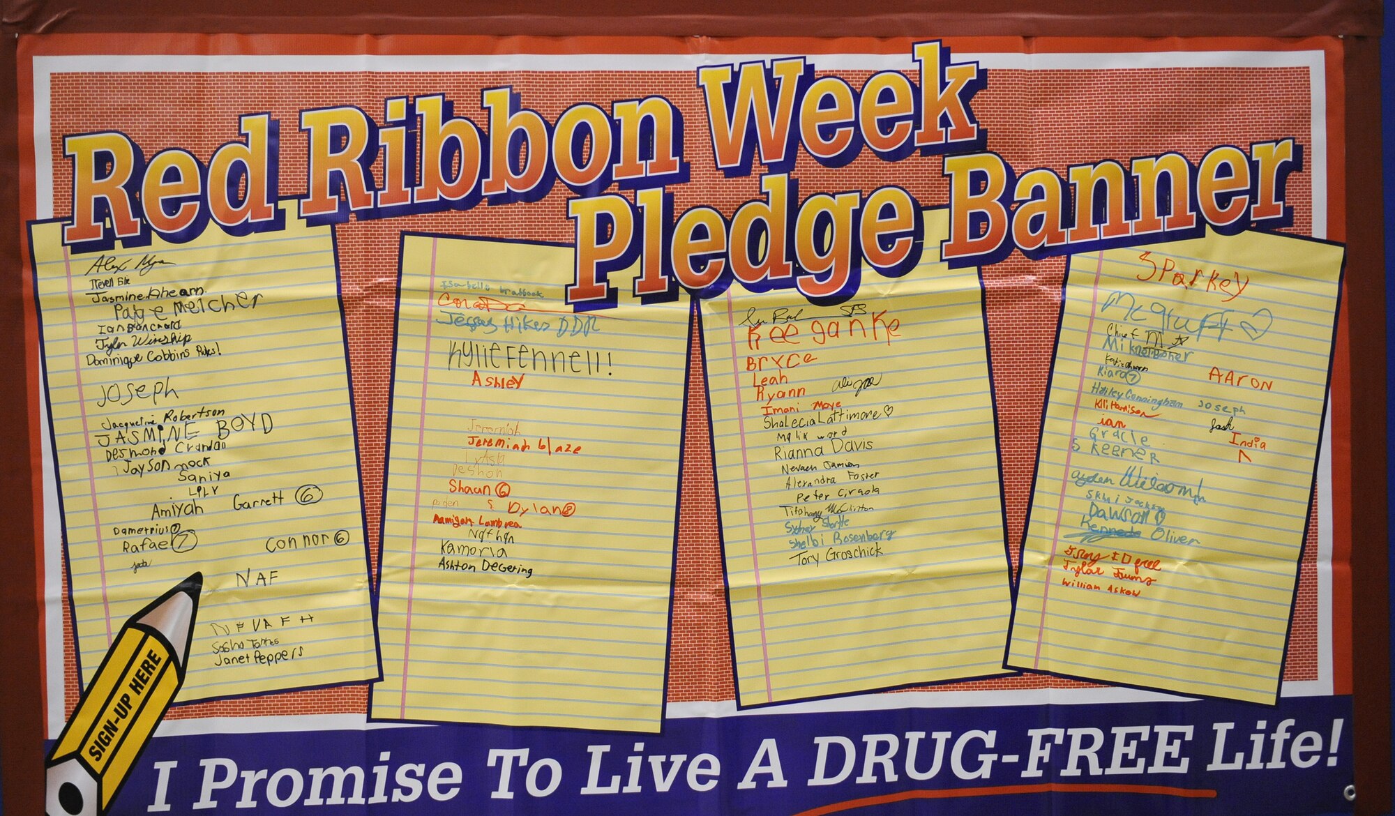 A banner containing signatures from members of Team Barksdale hangs on display at the youth center for Red Ribbon Week on Barksdale Air Force Base, La., Oct. 30. Red Ribbon Week is dedicated to inform the community on the dangers of drug and alcohol abuse. It is celebrated annually from Oct. 23-31. This year's theme is "The Best Me Is Drug Free!" (U.S. Air Force photo/Airman 1st Class Benjamin Gonsier)(RELEASED)
