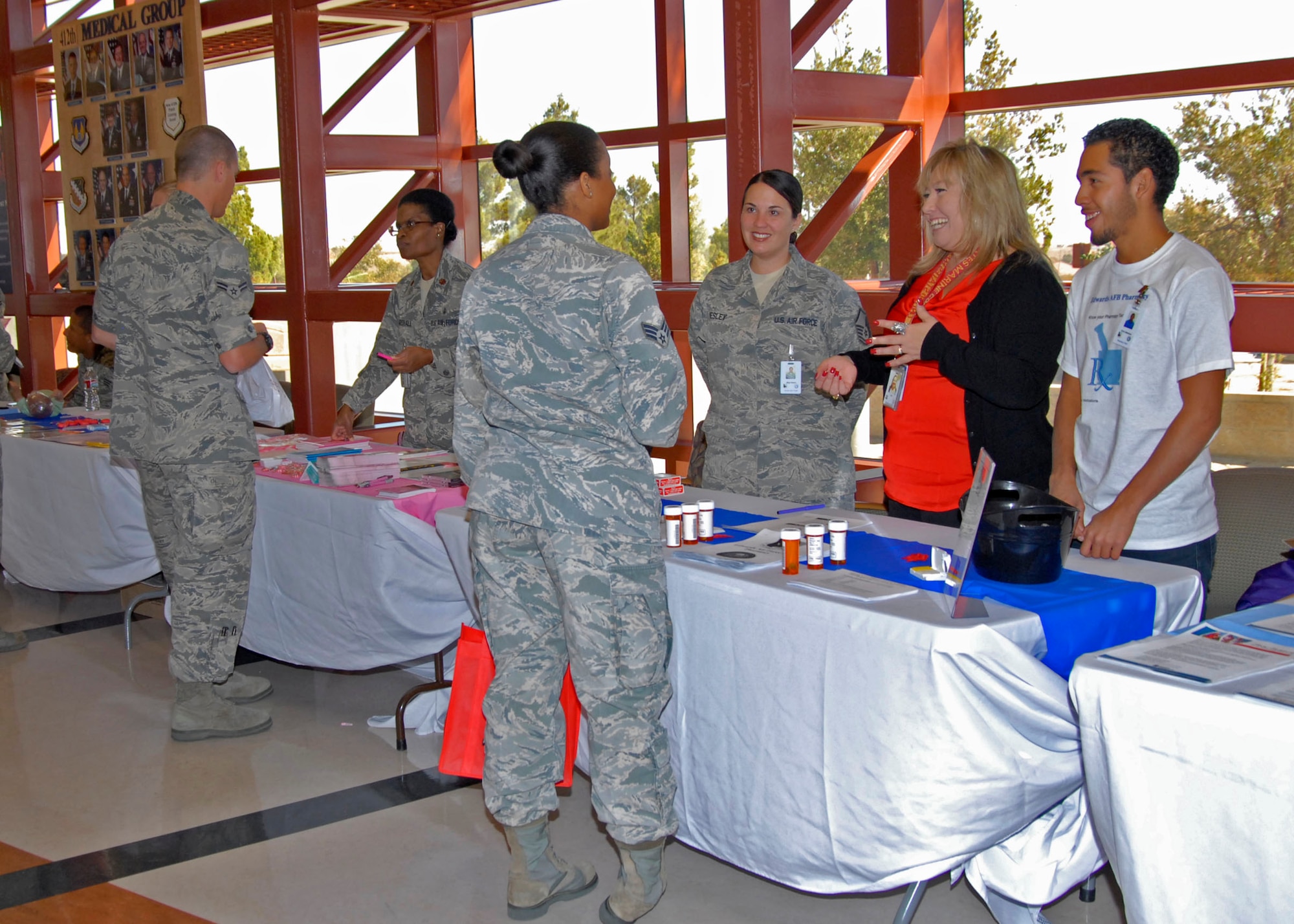 412th Medical Group personnel talk with attendees at the Health Fair held
Oct. 26 in the lobby of the Main Clinic. The event was aimed to create awareness
on key medical issues that the community faces. (Air Force Photo by Laura
Mowry)
