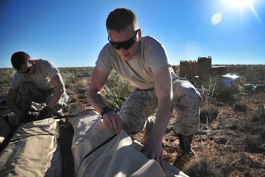 Airmen with the 27th Special Operations Wing at Cannon Air Force Base, N.M., work together to unload cargo and supplies during an exercise at Melrose Air Force Range, N.M., Oct. 29, 2012. Aircraft maneuvered troops and cargo from agencies across Cannon to better prepare personnel for potential real-world events. (U.S. Air Force photo/Airman 1st Class Alexxis Pons Abascal)  