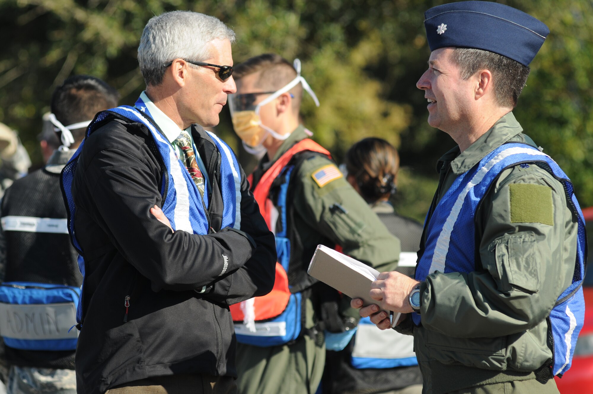 Jim Horton, Air Education and Training Command deputy inspector general, and Lt. Col. David Trout, AETC IG member, discuss the scenario during a hazardous material and major accident response exercise Oct. 31, 2012, at Hangar 4, Keesler Air Force Base, Miss.  The exercise scenario consisted of a group of Airmen cleaning inside the hangar in preparation for demolition when a shelf holding old munitions fell to the ground causing one to break open, explode and splash an “oily substance” on several of the “victims.”  The exercise helped prepare first responders in the event of a real-world incident.  (U.S. Air Force photo by Kemberly Groue)