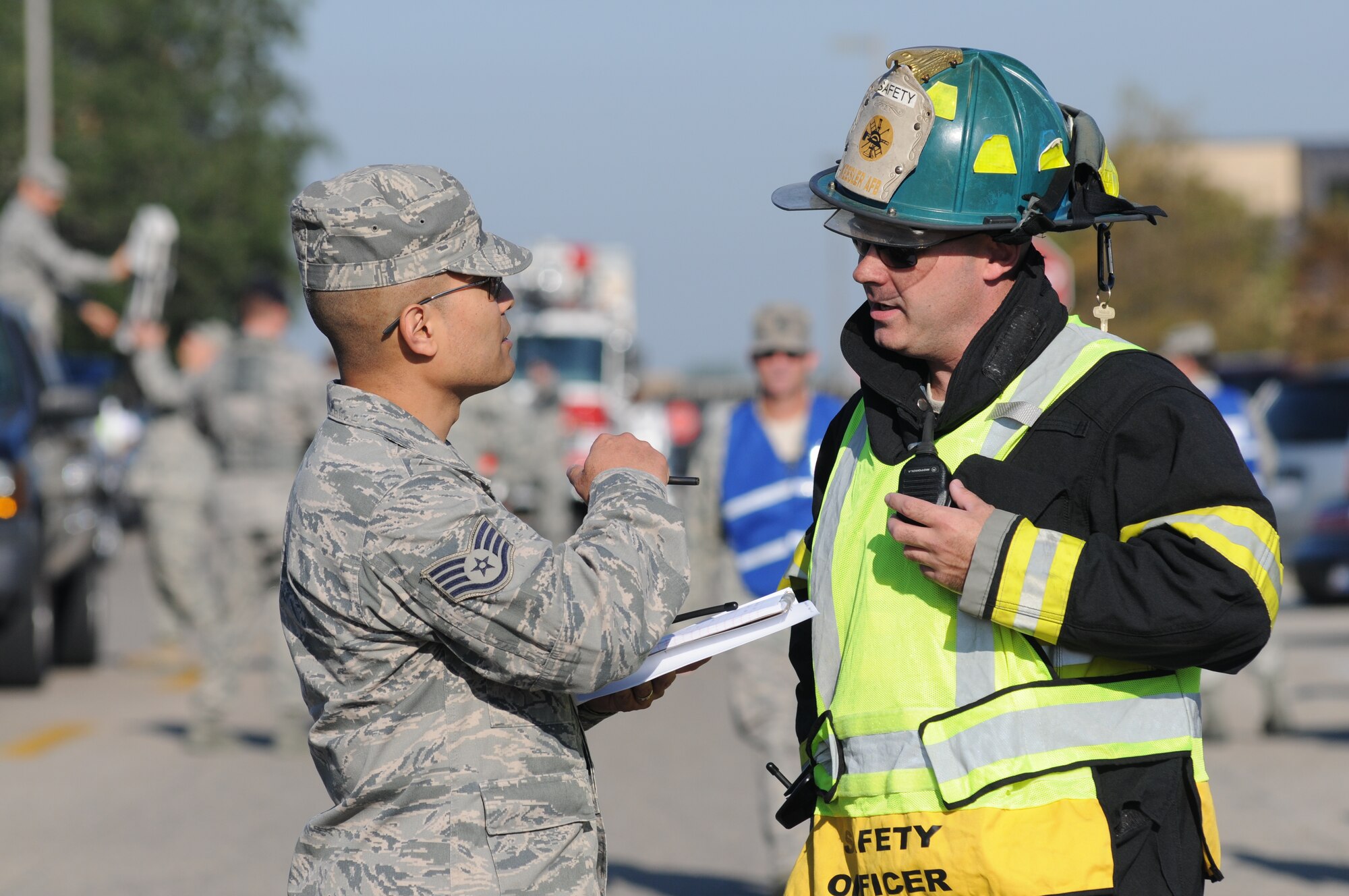 Staff Sgt. Billy Wince, jr., 81st Aerospace Medicine Squadron, and Master Sgt. Jerame Bullard, assess the situation on scene during a hazardous material and major accident response exercise Oct. 31, 2012, at Hangar 4, Keesler Air Force Base, Miss.  The exercise scenario consisted of a group of Airmen cleaning inside the hangar in preparation for demolition when a shelf holding old munitions fell to the ground causing one to break open, explode and splash an “oily substance” on several of the “victims.”  The exercise helped prepare first responders in the event of a real-world incident.  (U.S. Air Force photo by Kemberly Groue)