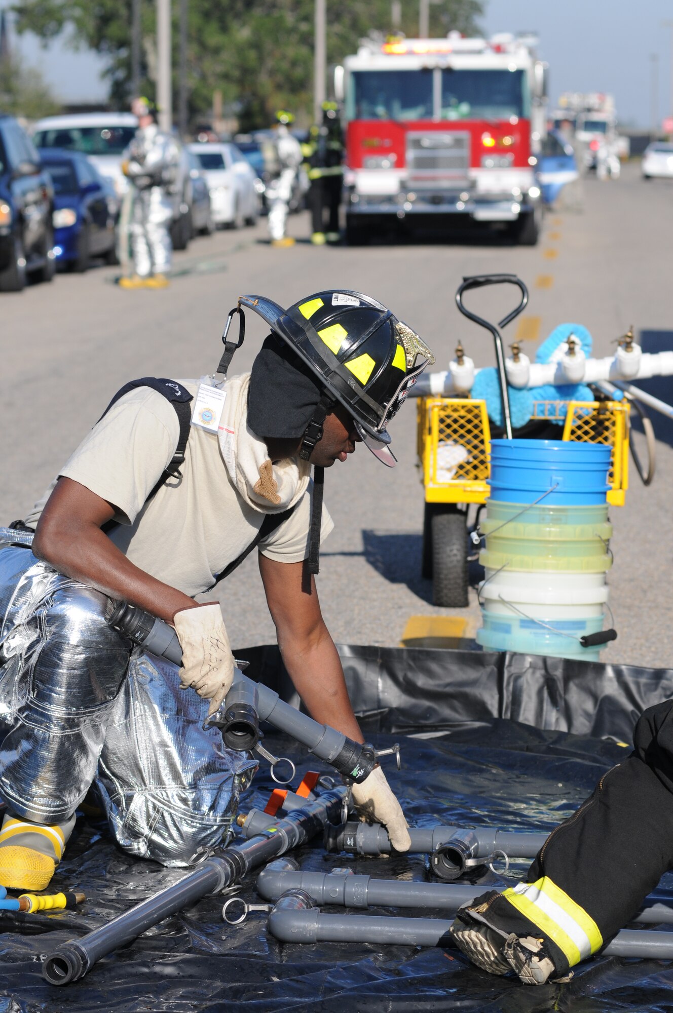 Tech. Sgt. Commie Hobbs, Keesler firefighter, assembles a hazardous material decontamination pool to be used for decontaminating “victims” during a hazardous material and major accident response exercise Oct. 31, 2012, at Hangar 4, Keesler Air Force Base, Miss.  The exercise scenario consisted of a group of Airmen cleaning inside the hangar in preparation for demolition when a shelf holding old munitions fell to the ground causing one to break open, explode and splash an “oily substance” on several of the “victims.”  The exercise helped prepare first responders in the event of a real-world incident.  (U.S. Air Force photo by Kemberly Groue)