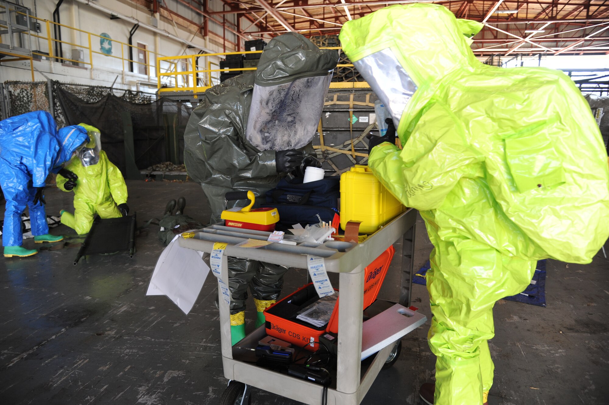 Tech. Sgts. Thomas Hefty and Christopher Bowens, 81st Aerospace and Medicine Squadron, collect chemical samples for laboratory confirmation and identification during a hazardous material and major accident response exercise Oct. 31, 2012, at Hangar 4, Keesler Air Force Base, Miss.  The exercise scenario consisted of a group of Airmen cleaning inside the hangar in preparation for demolition when a shelf holding old munitions fell to the ground causing one to break open, explode and splash an “oily substance” on several of the “victims.”  The exercise helped prepare first responders in the event of a real-world incident.  (U.S. Air Force photo by Kemberly Groue)