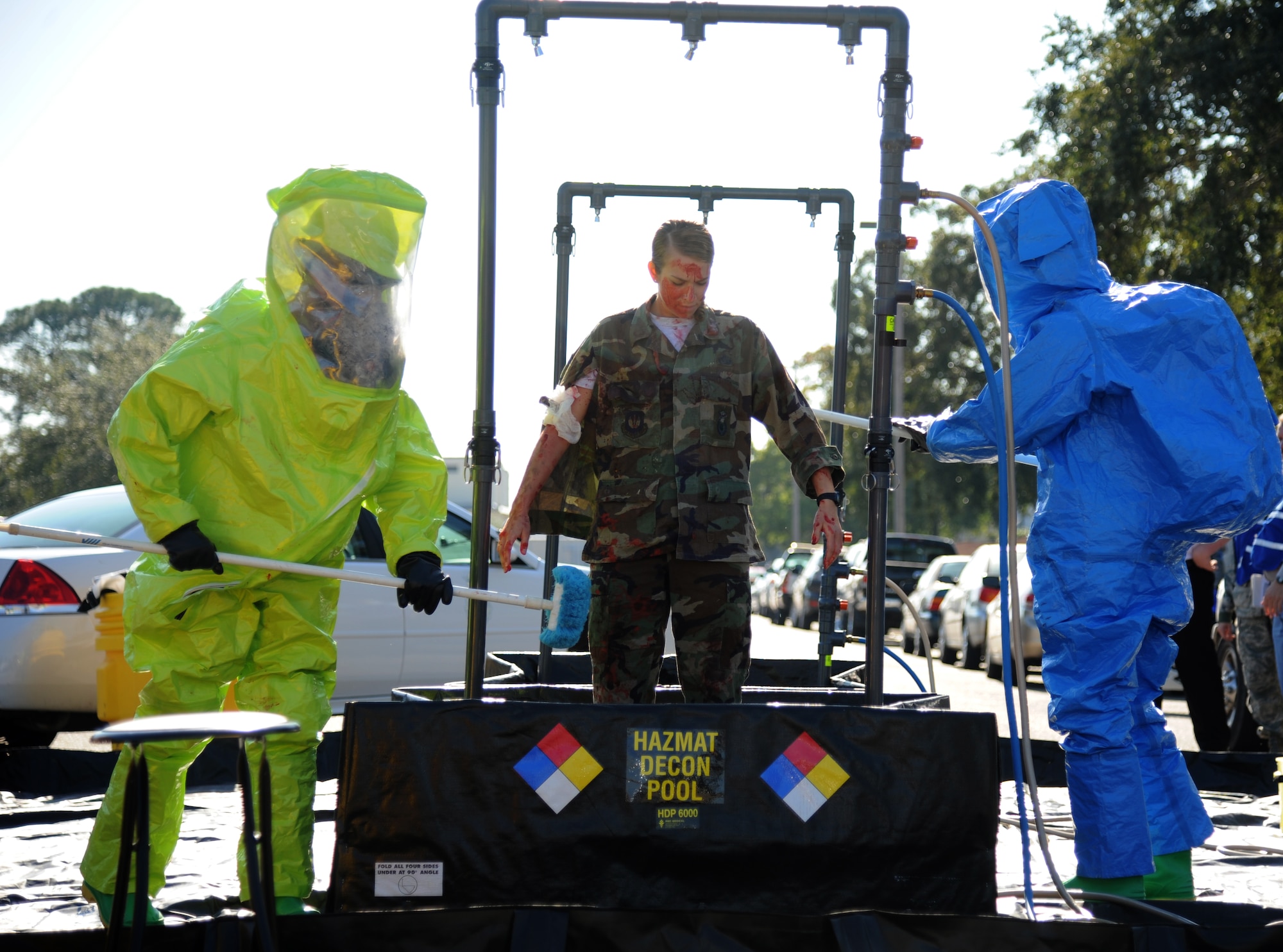 Members of the 81st Medical Group arrive on scene to assist with medical triage during a hazardous material and major accident response exercise Oct. 31, 2012, at Hangar 4, Keesler Air Force Base, Miss.  The exercise scenario consisted of a group of Airmen cleaning inside the hangar in preparation for demolition when a shelf holding old munitions fell to the ground causing one to break open, explode and splash an “oily substance” on several of the “victims.”  The exercise helped prepare first responders in the event of a real-world incident.  (U.S. Air Force photo by Kemberly Groue)