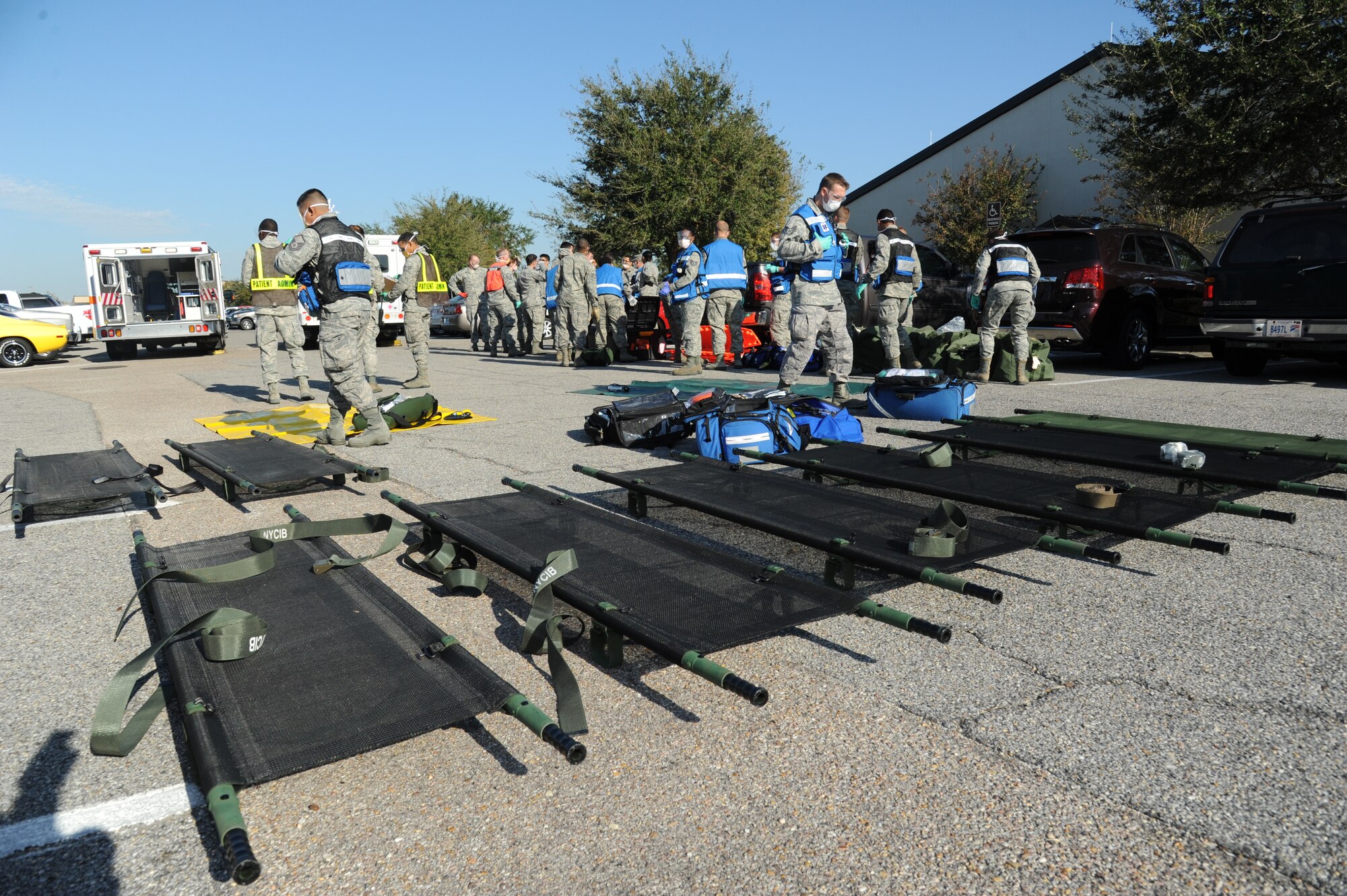 Members of the 81st Medical Group arrive on scene to assist with medical triage during a hazardous material and major accident response exercise Oct. 31, 2012, at Hangar 4, Keesler Air Force Base, Miss.  The exercise scenario consisted of a group of Airmen cleaning inside the hangar in preparation for demolition when a shelf holding old munitions fell to the ground causing one to break open, explode and splash an “oily substance” on several of the “victims.”  The exercise helped prepare first responders in the event of a real-world incident.  (U.S. Air Force photo by Kemberly Groue)