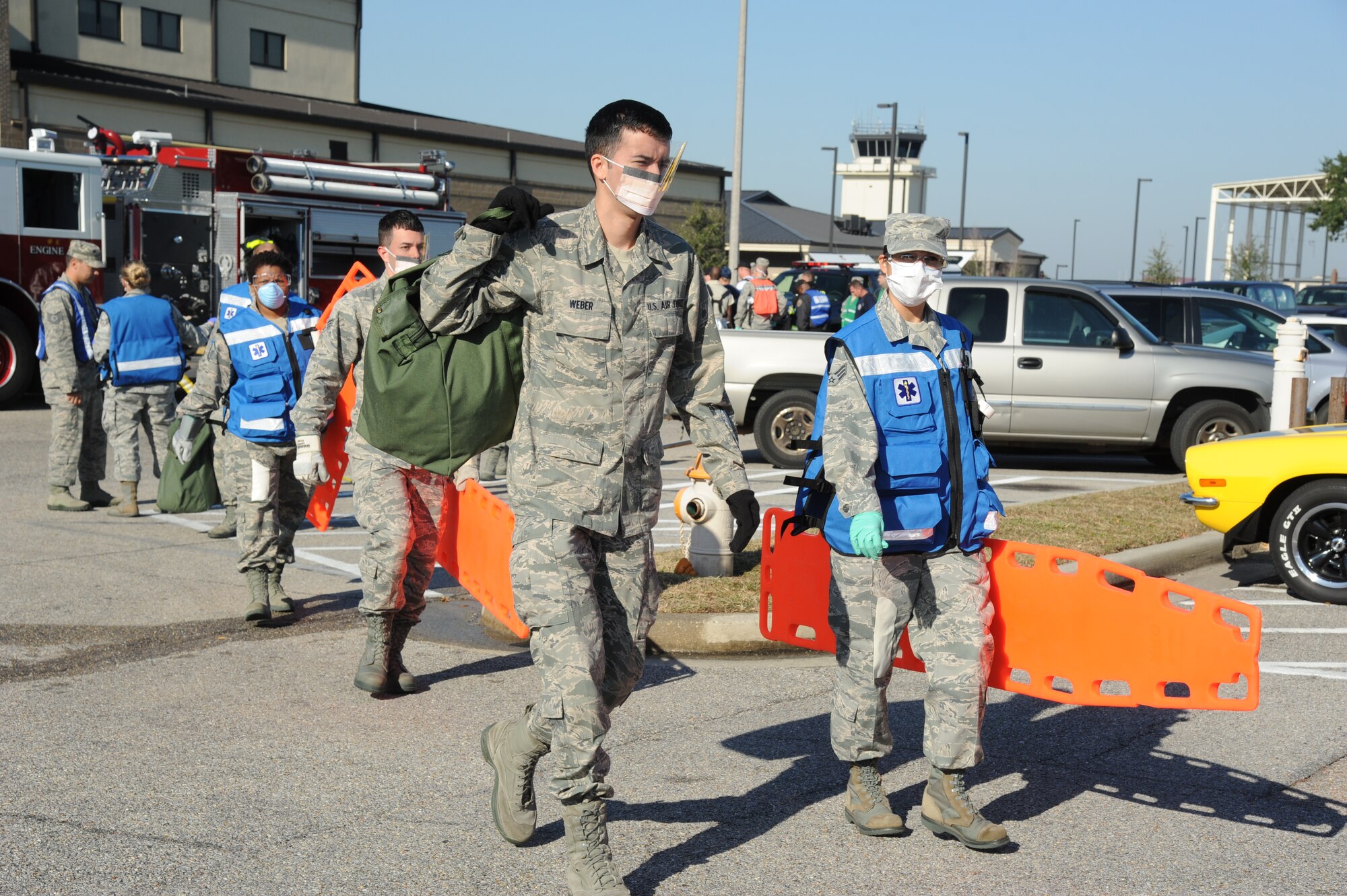 Members of the 81st Medical Group arrive on scene to assist with medical triage during a hazardous material and major accident response exercise Oct. 31, 2012, at Hangar 4, Keesler Air Force Base, Miss.  The exercise scenario consisted of a group of Airmen cleaning inside the hangar in preparation for demolition when a shelf holding old munitions fell to the ground causing one to break open, explode and splash an “oily substance” on several of the “victims.”  The exercise helped prepare first responders in the event of a real-world incident.  (U.S. Air Force photo by Kemberly Groue)