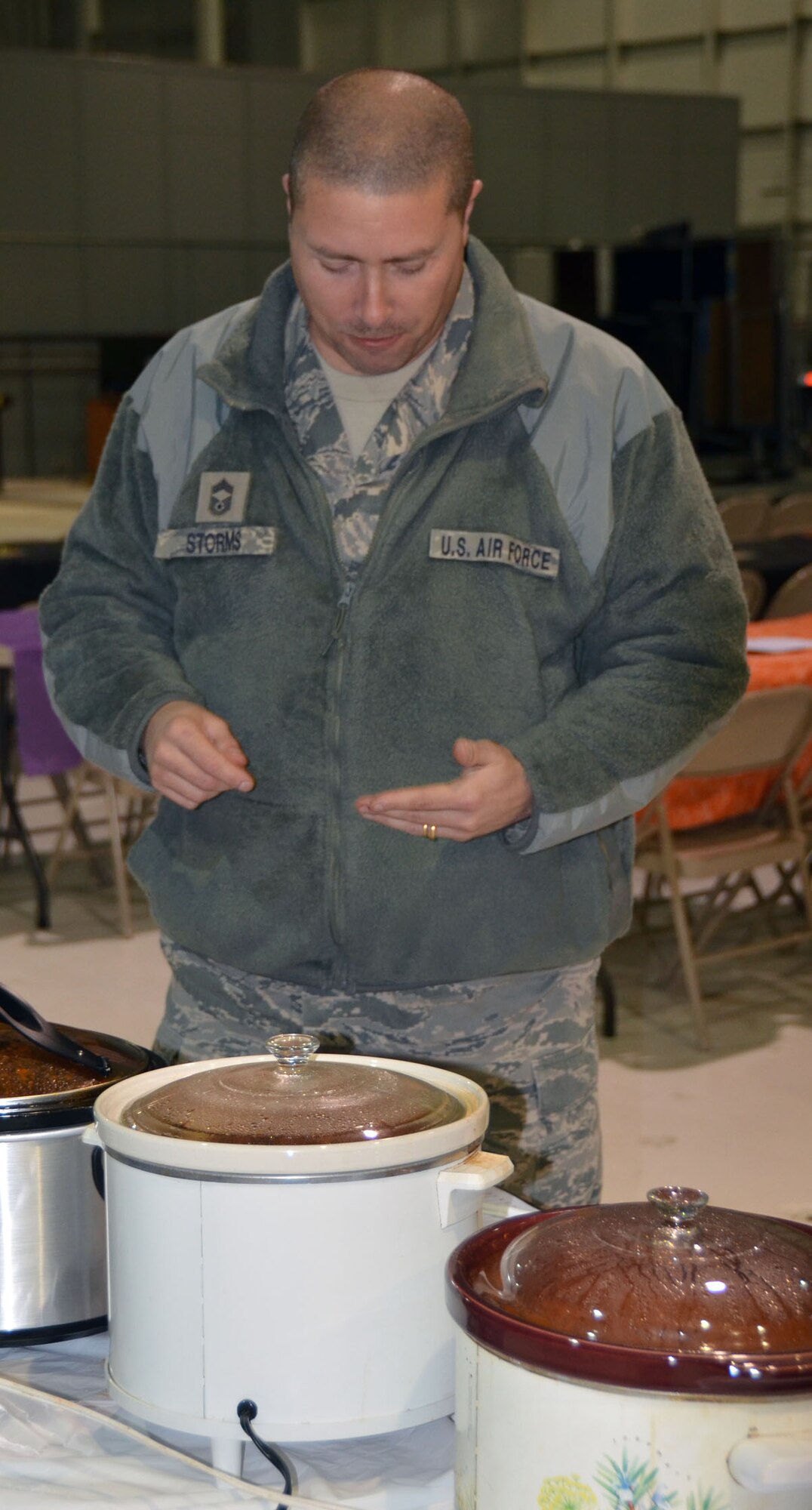 WRIGHT-PATTERSON AIR FORCE BASE, Ohio - Chief Master Sgt. Sean Storms, 87th Aerial Port Squadron, air transportation superintendent, ponders a sample of chili for taste and texture while judging the 445th Airlift Wing Chili Cook-off that raised $380 for the Combined Federal Campaign. (U.S. Air Force photo/Stacy Vaughn)