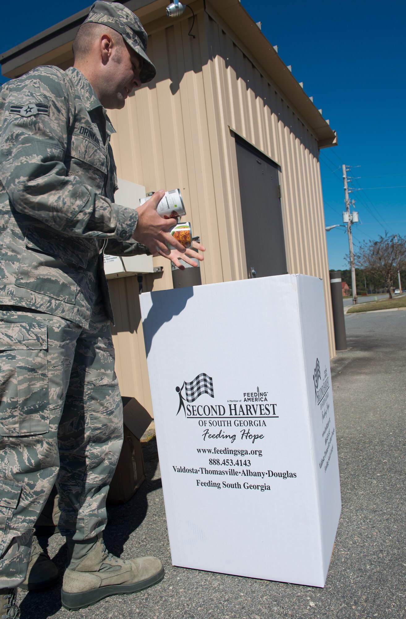U.S. Air Force Airman 1st Class Marcus Drinkard, 23d Contracting Squadron contracting specialist, donates canned food to the Second Harvest of South Georgia at Moody Air Force Base, Ga., Oct. 30, 2012. Moody donated nearly 3,000 pounds of canned food which will feed approximately 200 people for two weeks. (U.S. Air Force photo by Senior Airman Douglas Ellis/Released)  

