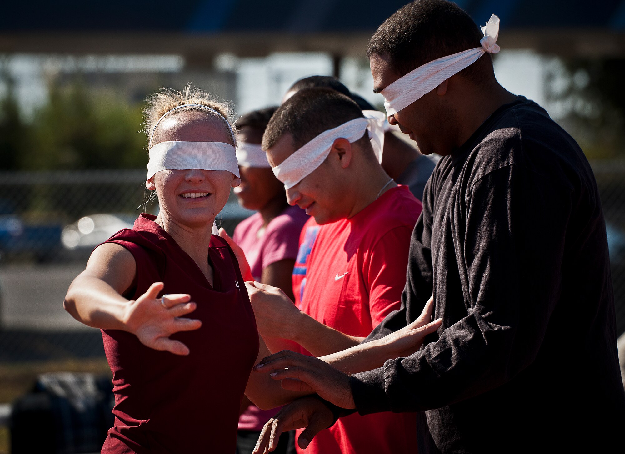Senior Airman Erin McBride, of the 96th Medical Group, searches for another teammate at the 96th Test Wing’s Wingman Day event Oct. 31 at Eglin Air Force Base, Fla.  McBride and her team had to arrange themselves in numbered order while blindfolded and without speaking.  Hundreds of Airmen and civilians participated in physical and non-physical challenges highlighting teamwork and resiliency.  (U.S. Air Force photo/Samuel King Jr.)