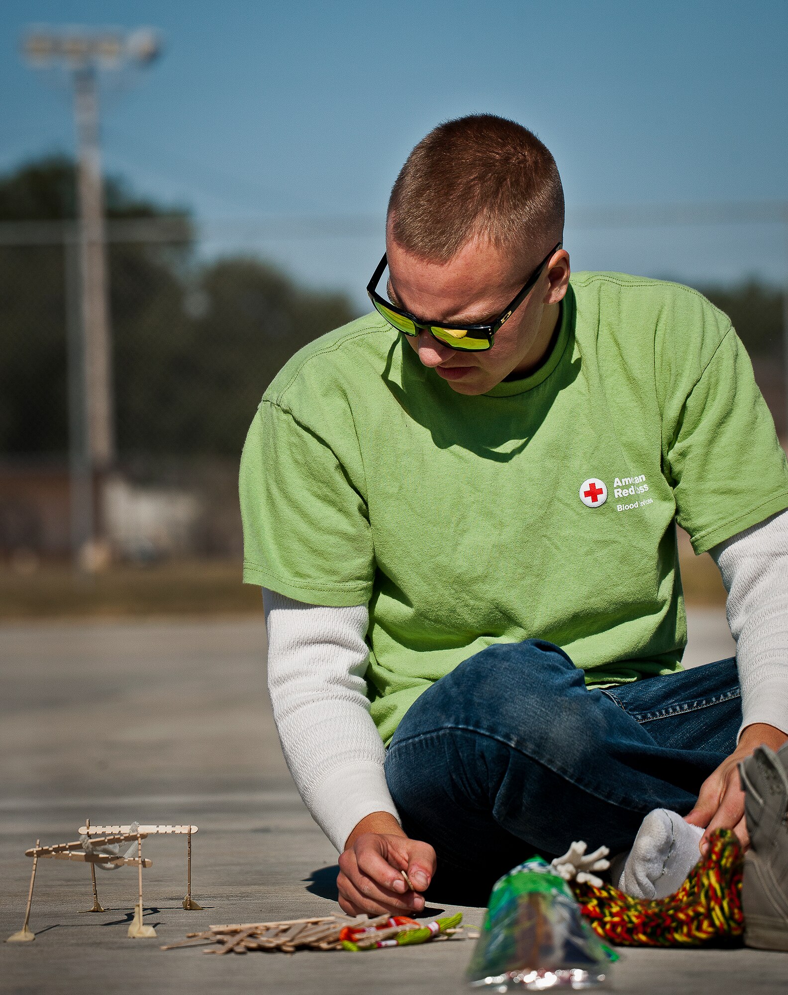 An Airman works on building a bridge out of sticks at the 96th Test Wing’s Wingman Day event Oct. 31 at Eglin Air Force Base, Fla.  Hundreds of Airmen and civilians participated in physical and non-physical challenges highlighting teamwork and resiliency.  (U.S. Air Force photo/Samuel King Jr.)