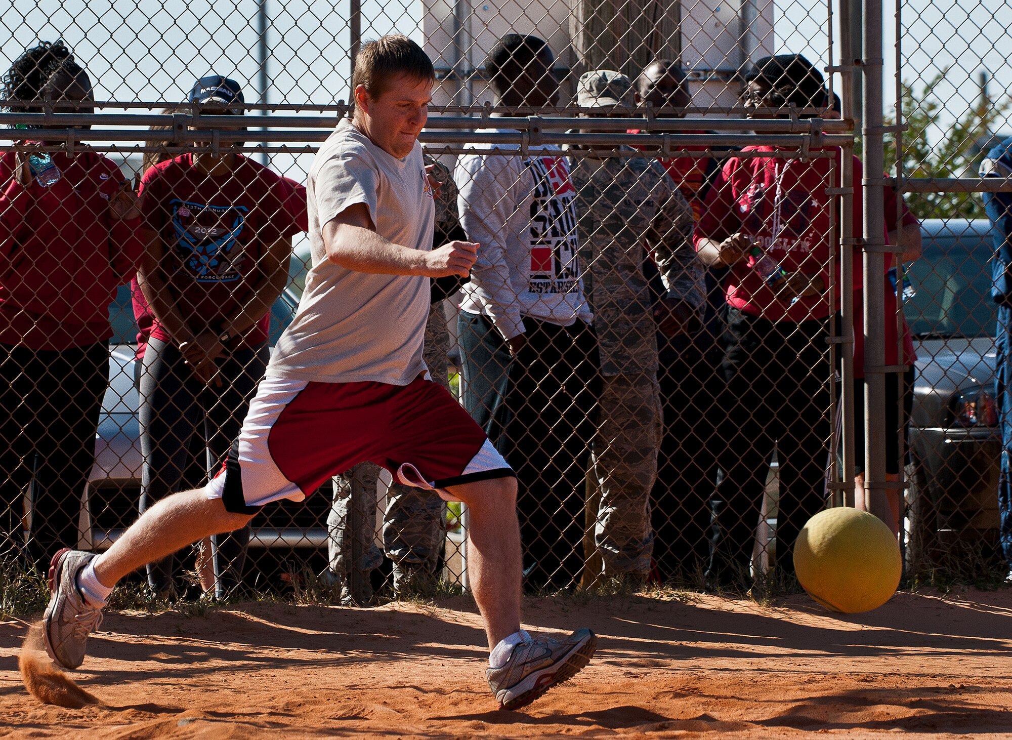 An Airman aims his kick during a kickball match at the 96th Test Wing’s Wingman Day event Oct. 31 at Eglin Air Force Base, Fla.  Hundreds of Airmen and civilians participated in physical and non-physical challenges highlighting teamwork and resiliency.  (U.S. Air Force photo/Samuel King Jr.)