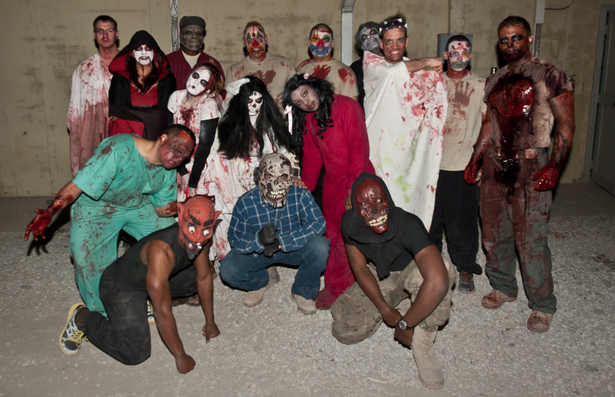U.S. Army, Air Force, and DoD civilians pose during a break while volunteering at a “haunted house” at Bagram Airfield Afghanistan, Oct. 31, 2012. The "haunted house” was open for six evenings. More than 300 people showed up to enjoy their spare time or duties at the house each night. (U.S. Air Force photo/Staff Sgt. Jeff Nevison)