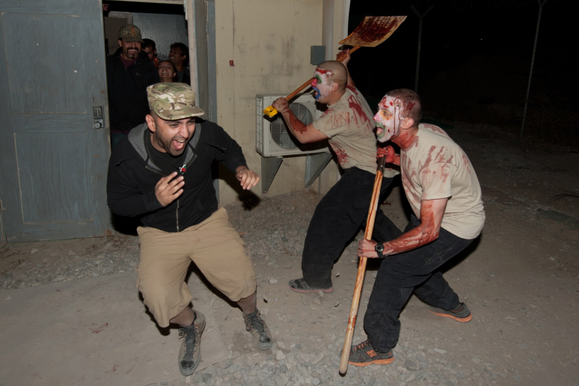 A U.S. Department of Defense civilian (left) is frightened by two “zombie” Army Soldiers dressed up at a “haunted house” at Bagram Airfield, Afghanistan, Oct. 31, 2012. Army, Air Force, and DoD civilians volunteered for three weeks to prepare the house. The “haunted house” was open for six evenings. More than 300 people showed up to enjoy their spare time or duties at the house each night. (U.S. Air Force photo/Staff Sgt. Jeff Nevison)