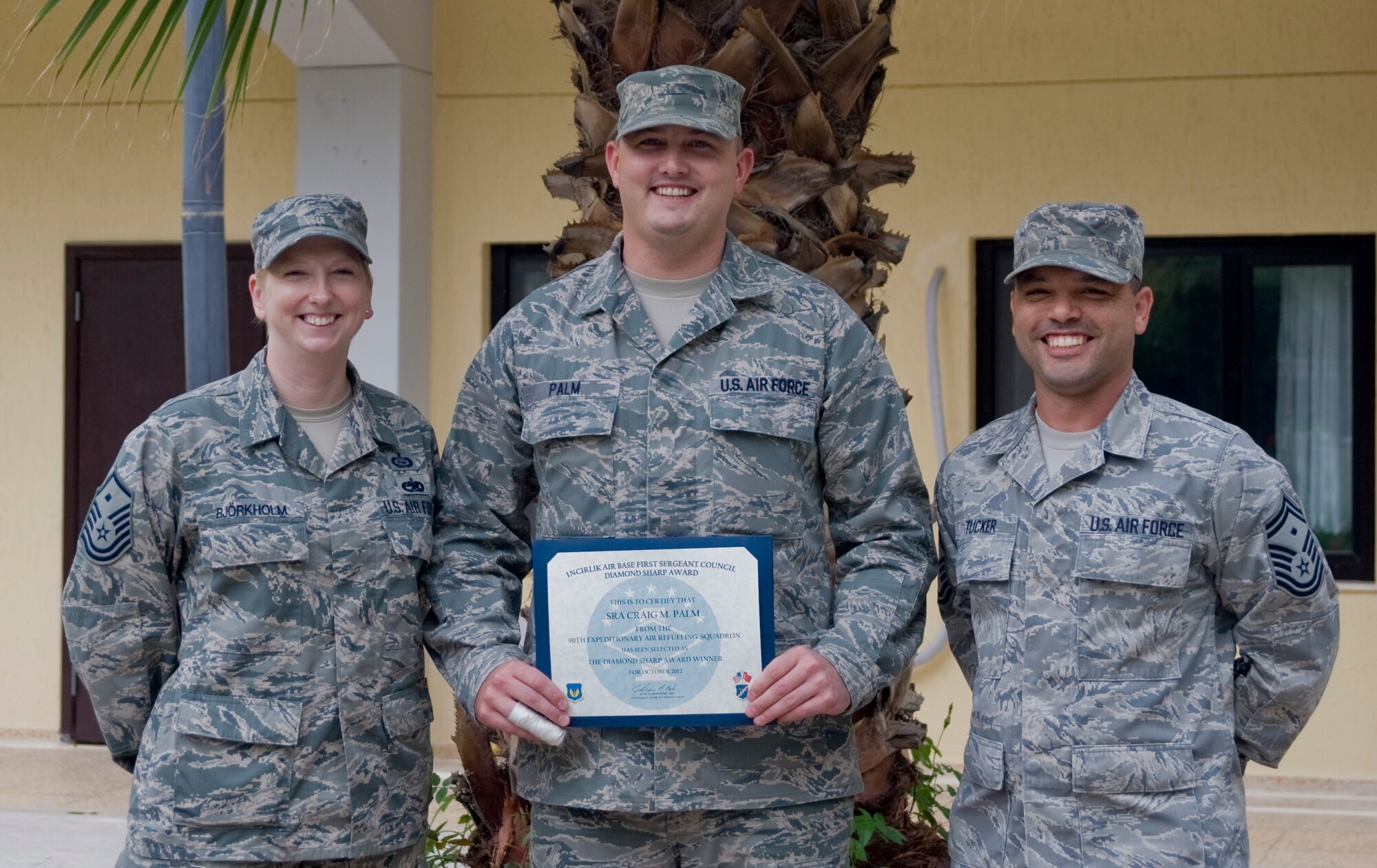 Senior Airman Craig Palm, 90th Expeditionary Air Refueling Squadron, center, is presented the October 2012 Diamond Sharp Award by members of the Incirlik First Sergeant Council Oct. 31, 2012, at Incirlik Air Base, Turkey. Palm earned the monthly award by distinguishing himself through outstanding professionalism, performance and display of the Air Force core values. (U.S. Air Force photo by Senior Airman Anthony Sanchelli/Released)
