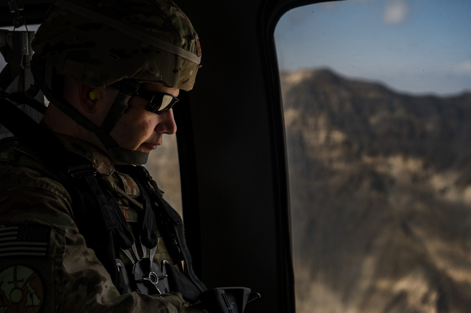 U.S. Air Force Maj. Ryan Kehoe, 19th Expeditionary Weather Squadron, director of operations, travels on a U.S. Army UH-60 Black Hawk back to Bagram Airfield after visiting with 19th EWS Airmen at remote forward operating bases on Oct. 16, 2012, over Afghanistan. The 19th EWS provides Army ground commanders with accurate and real-time weather conditions and offers alternative options to help commanders make informed decisions on combat operations. (U.S. Air Force photo/Staff Sgt. Jonathan Snyder)