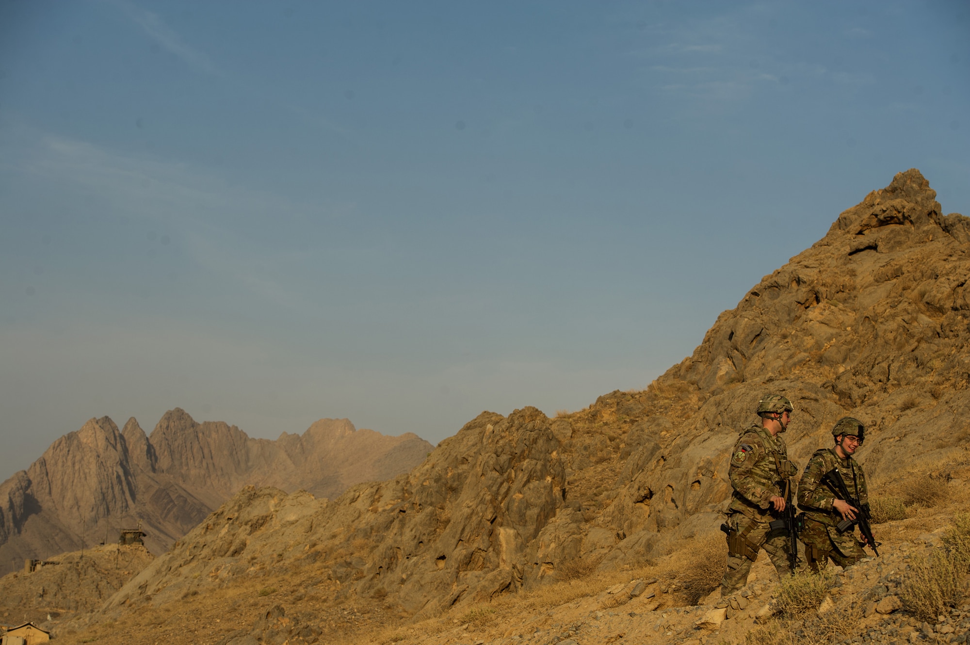 U.S. Air Force Staff Sgt. Adam Gagne, left, and Senior Airman Adam Chmielowski, both 19th Expeditionary Weather Squadron battlefield weather forecasters, make their way to an observation point on Oct. 10, 2012, at Forward Operating Base Masum Ghar, Afghanistan. The 19th EWS provides Army ground commanders with accurate and real-time weather conditions and offers alternative options to help commanders make informed decisions on combat operations. (U.S. Air Force photo/Staff Sgt. Jonathan Snyder)