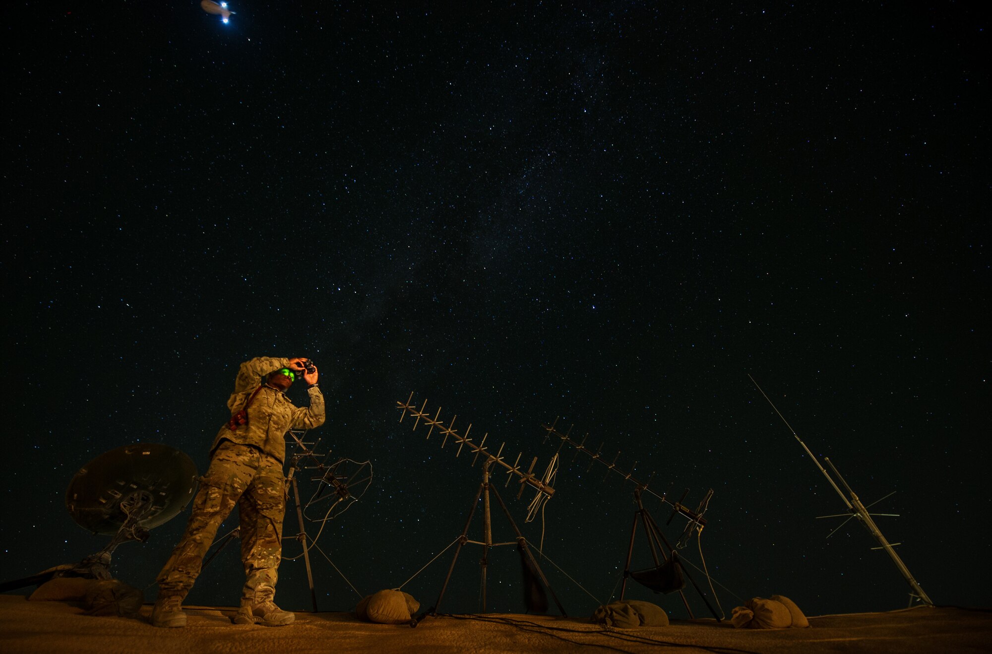 U.S. Air Force Tech. Sgt. Omar Nurse, battlefield weather forecaster, 19th Expeditionary Weather Squadron, uses night vision goggles to conduct a weather observation, making sure visibility and climate matches the main weather sensor data on Oct. 7, 2012, at Forward Operating Base Shank, Afghanistan. The 19th EWS provides Army ground commanders with accurate and real-time weather conditions and offers alternative options to help commanders make informed decisions on combat operations. (U.S. Air Force photo/Staff Sgt. Jonathan Snyder)