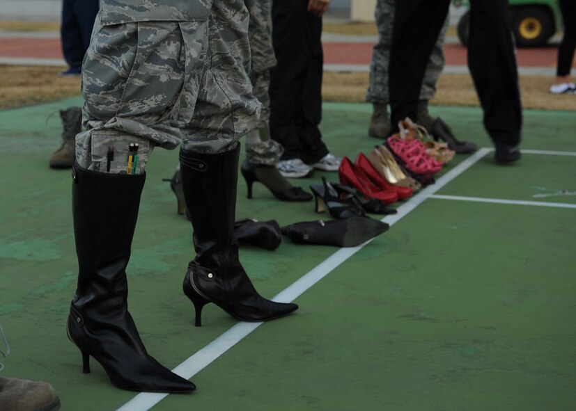 Volunteers put on high heels in support of the Walk-A-Mile-In-Her-Shoes event on Kunsan Air Base, Republic of Korea, Oct. 31, 2012. The event was held to bring awareness to domestic violence and a push to end it. (U.S. Air Force photo/Staff Sgt. Jonathan Fowler)