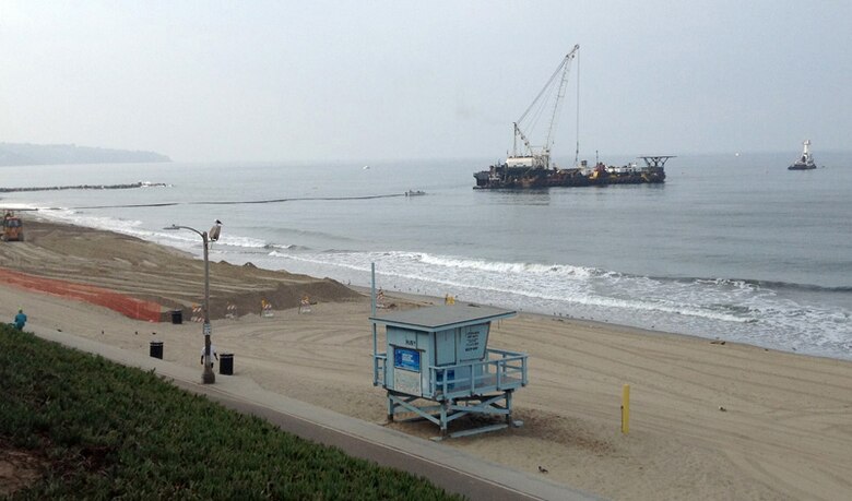 Dutra Dredging Company puts the final touches on the placement of nearly 75,000 cubic yards of sand at Redondo Beach as part of the Marina del Rey entrance channel navigation project shortly before the dredge Paula Lee departed and bulldozers contoured the sand to meet the required beach profiles, leaving residents and visitors with a wider, more protective beach. 