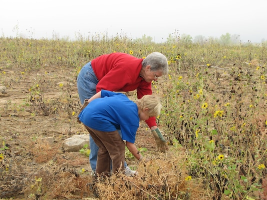 JOHN MARTIN RESERVOIR, COLO., -- Volunteers Deborah West and her granddaughter Kyra Bierbaum pulled weeds and sunflowers on the south shore of John Martin Reservoir to help promote critical nesting habitat for the Piping Plover and Interior Least Tern at the 2012 National Public Lands Day event held at the reservoir.