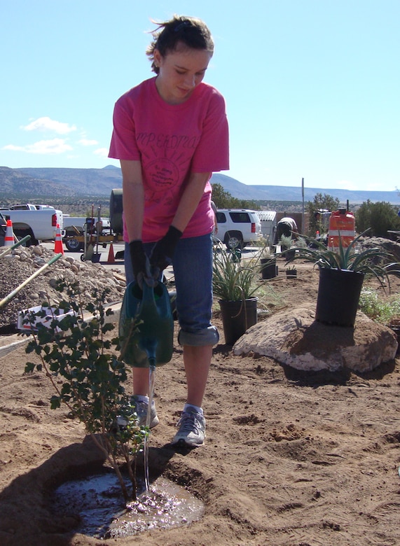 COCHITI LAKE, N.M., -- Volunteer Adrianne Bonham helps plant desert vegetation to improve landscaping at Cochiti at the National Public Lands Day event held there, Sept. 29, 2012.