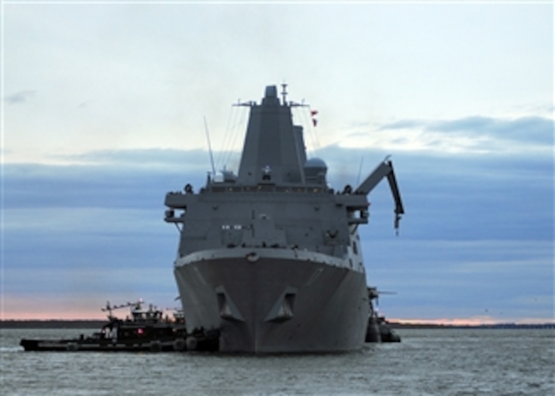 Tugboats push the amphibious transport dock ship USS San Antonio (LPD 17) away from the pier as the ship departs Naval Station Norfolk, Va., on Oct. 31, 2012.  The San Antonio is getting underway for New Jersey to conduct relief operations in the wake of Hurricane Sandy.  