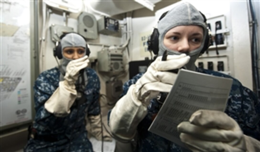 U.S Navy Firemen Carady Madden, right, and Romika Kumar, left, stand watch as phone talkers in repair locker 7-B during a general quarters drill aboard the aircraft carrier USS John C. Stennis (CVN 74) as the ship operates in the Arabian Sea on Oct. 30, 2012.  The Stennis is deployed to the 5th Fleet area of responsibility to conduct maritime security operations and theater security cooperation efforts.  