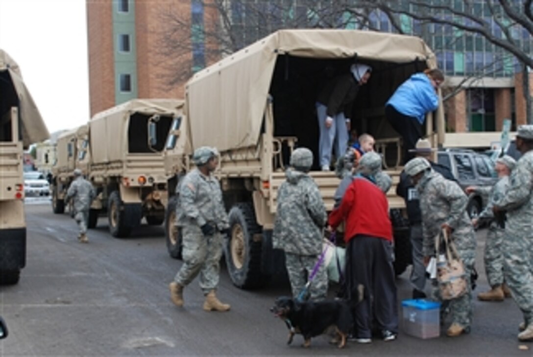 Soldiers from the New York Army National Guard assist residents displaced by Hurricane Sandy as they arrive at Long Beach City Hall in Long Beach, N.Y., on Oct. 30, 2012.  The soldiers are attached to Foxtrot Company of the 427th Brigade Support Battalion.  