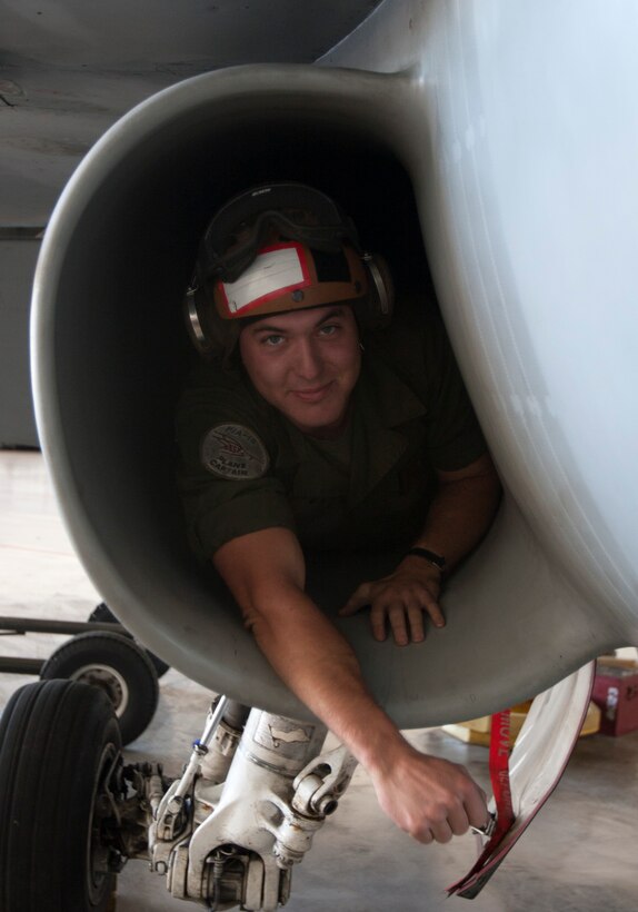 Lance Cpl. Nicholas Levins, an F/A-18 aircraft mechanic with Marine Fighter Attack Squadron 323 and an Issaquah, Wash., native, poses inside of an intake of an F/A-18 Hornet aboard Marine Corps Air Station Miramar, Calif., Oct. 25. Plane captains inspect the aircraft prior to the pilot coming out, conduct a walk through with the pilot, and a post-flight inspection once the aircraft returns. 