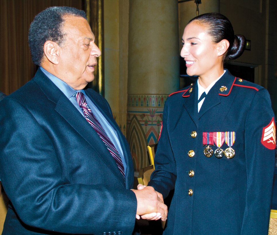 Sgt. JoAnna Sudduth, legal noncommissioned officer-in-charge, Office of the Staff Judge Advocate, Marine Corps Logistics Base Albany, is congratulated by former United Nations Ambassador, Andrew Young, during a presentation ceremony at the Fox Theater in Atlanta, Oct. 24.  Sudduth was selected as one of Georgia Trend's 2012 40 Under 40 Best and Brightest in Georgia.

