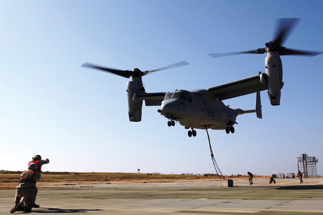 An MV-22B Osprey takes off after landing support specialists attached a 7,000-pound concrete block during dual-point external training on Ie Shima Oct. 25. Marine Medium Tiltrotor Squadron 265 recently switched from the CH-46E Sea Knight helicopter to the Osprey, which allows for dual-point external operations at faster speeds. The landing support specialists are with Combat Logistics Regiment 37, 3rd Marine Logistics Group, III Marine Expeditionary Force. The pilot and crew are with VMM-265, 1st Marine Aircraft Wing, III MEF. 