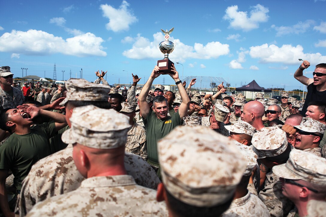 Lt. Col. Darin J. Clarke holds up the championship trophy at the 2nd annual super squadron competition at Marine Corps Air Station Futenma Oct. 26. Clarke's unit, Marine Wing Support Squadron 172, earned the most points throughout 10 rigorous events to claim first place. Clarke is the commanding officer of MWSS-172.