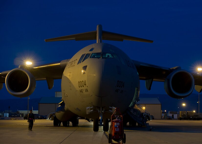 A C-17 Globemaster III from the 89th Airlift Squadron sits on the 49th Materiel Maintenance Group runway at Holloman Air Force Base, N.M., Nov. 2. The C-17 was here to pick up cargo that was packed by the 49th Materiel Maintenance Squadron. The 49th MMS was tasked with supporting the humanitarian relief efforts for the victims of Hurricane Sandy. In response to the tasking, the 49th MMS worked for 15 straight hours preparing more than 58,000 pounds of cargo spread across eight pallets. The cargo consisted of two water pumps capable of pumping 400 gallons of water per minute, 12,000 feet of hose, and two containers of system support items.  (U.S. Air Force photo by Senior Airman DeAndre Curtiss/Released)