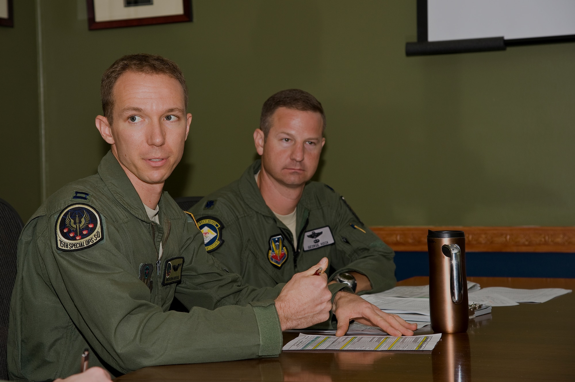 (From left) U.S. Air Force Capt. Andrew Gregg, a MC-130H pilot of 15th Special Operations Squadron, and Lt. Col. George Hock, director of operations of 14th Weapons Squadron, sit in on a brief for instructors and their students on a training flight at Hurlburt Field, Fla., Oct. 11, 2012. The 14th WPS produces well-trained experts who return to their respective units after graduation to raise the collective skill set of the community. (U.S. Air Force Photo/Airman 1st Class Michelle Vickers)