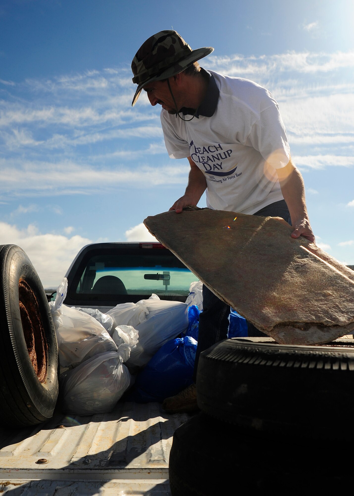 VANDENBERG AIR FORCE BASE, Calif. -- Adam Bray, Tetra Tech environmental engineer, loads a truck with trash and recyclables picked-up by a  beach cleanup crew, Nov. 1, 2012. Bray was part of a volunteer group participating in the 2012 Beach Cleanup Day at Ocean Park on Vandenberg AFB. (U.S. Air Force Photo/Michael Peterson)