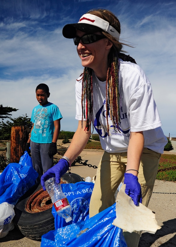 VANDENBERG AIR FORCE BASE, Calif. -- Lauren Wilson, 30th Civil Engineer Squadron biologist, bags a few pieces of trash for a collection pile Thursday, Nov. 1, 2012. Wilson was part of a volunteer group participating in the 2012 Beach Cleanup Day at  Ocean Park on Vandenberg AFB. (U.S. Air Force Photo/Michael Peterson)